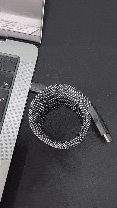 USB C magnetic cable roll out plugged into laptop